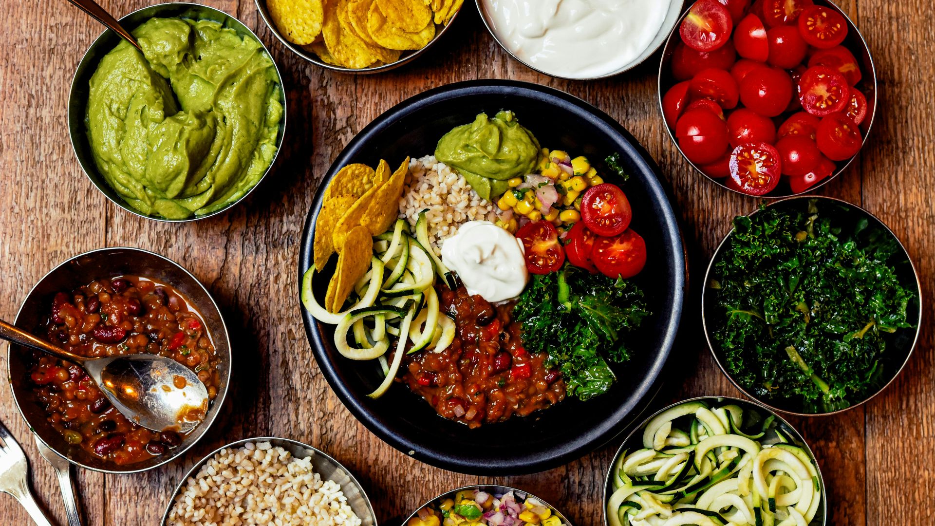 sliced vegetables and fruits on black ceramic plate