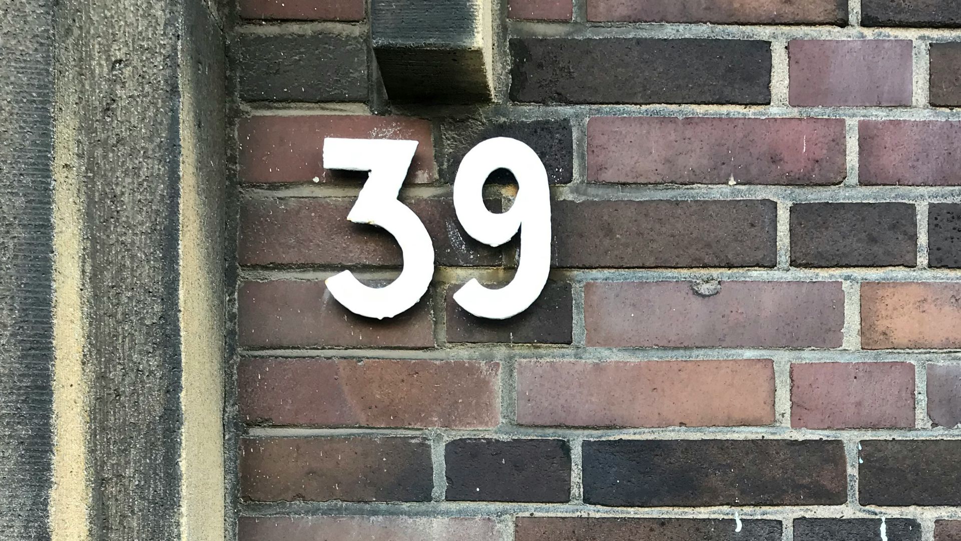 a brick wall with a sign on it