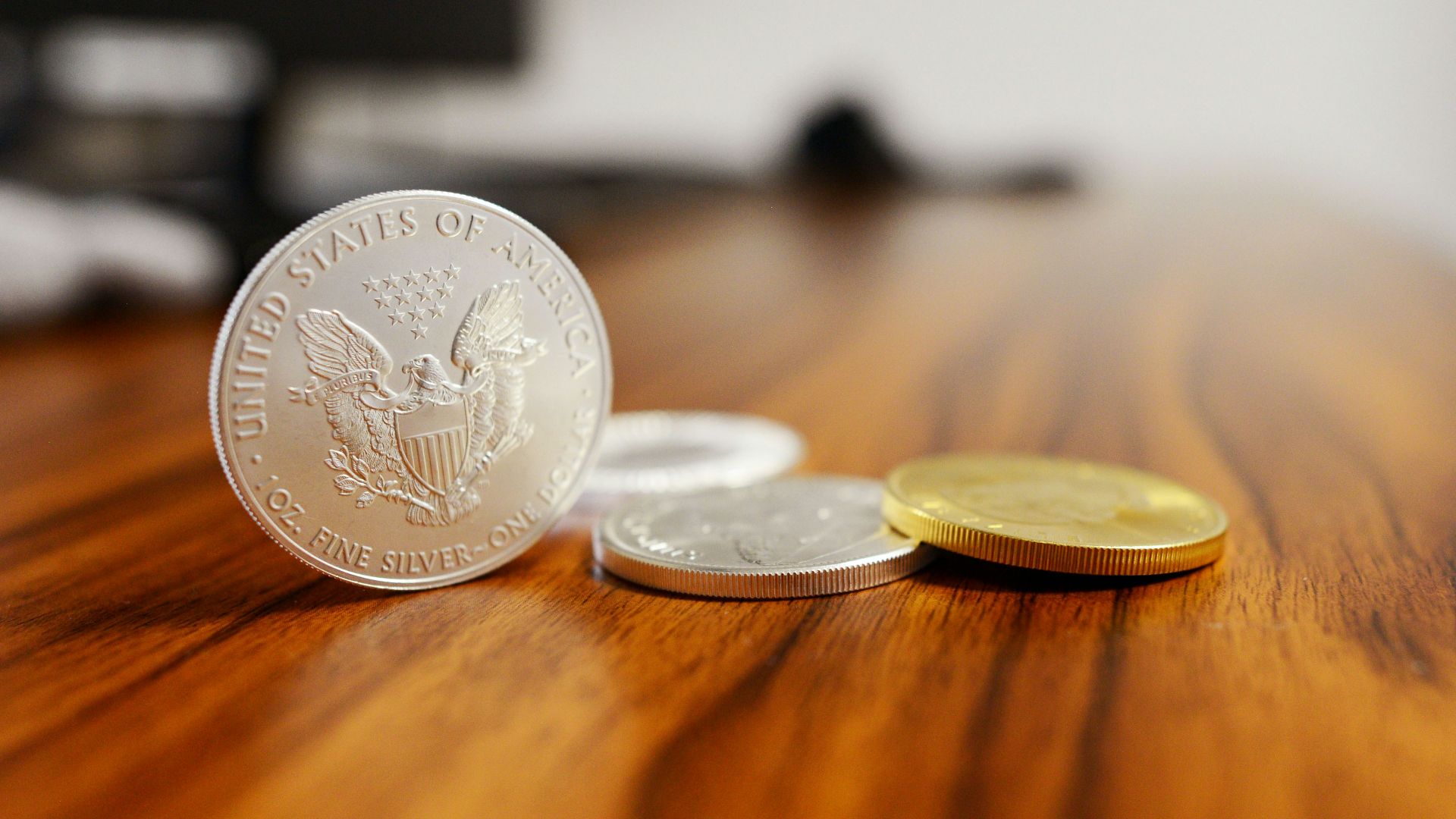 silver round coins on brown wooden table