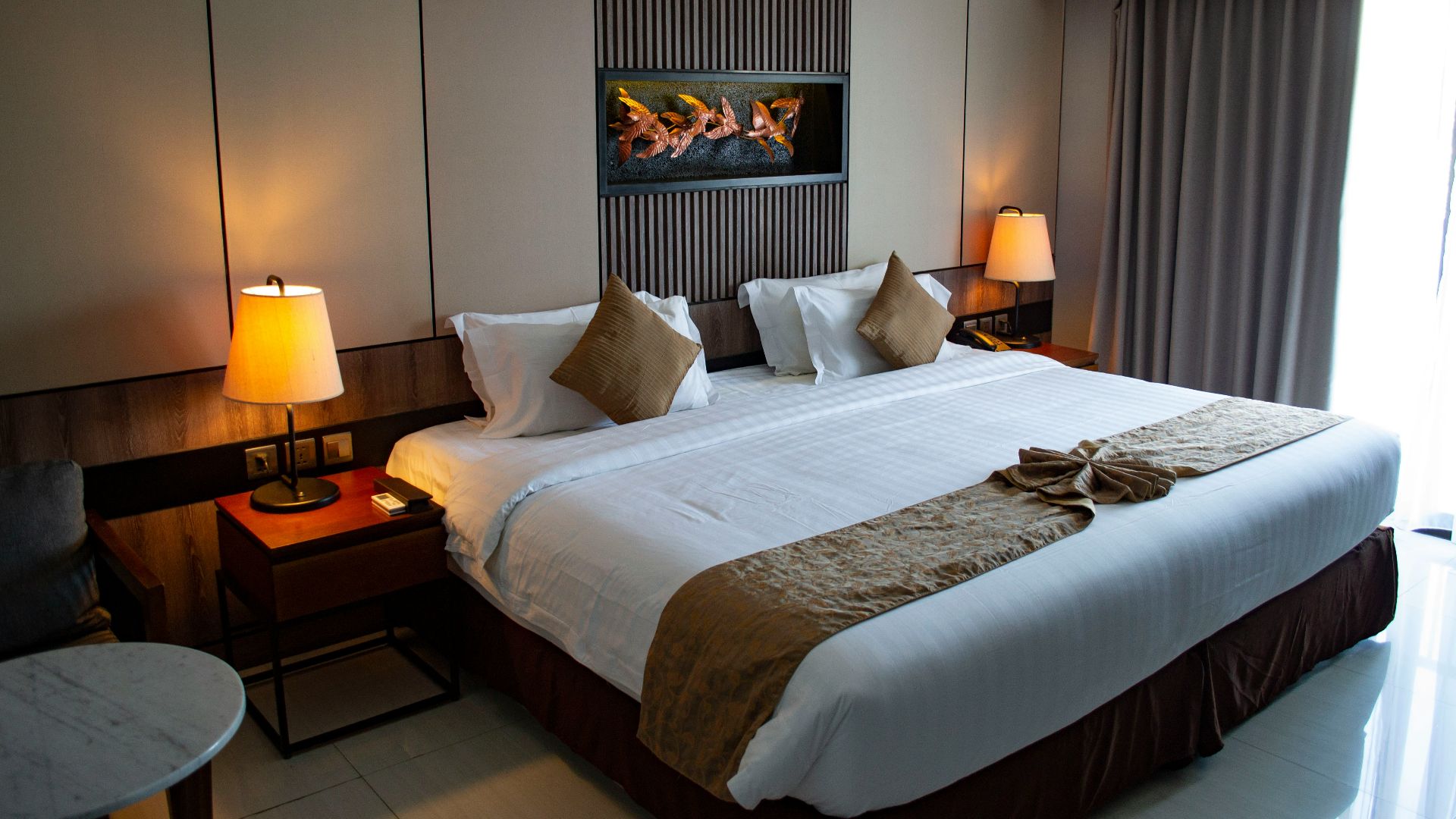 white bed linen with throw pillows