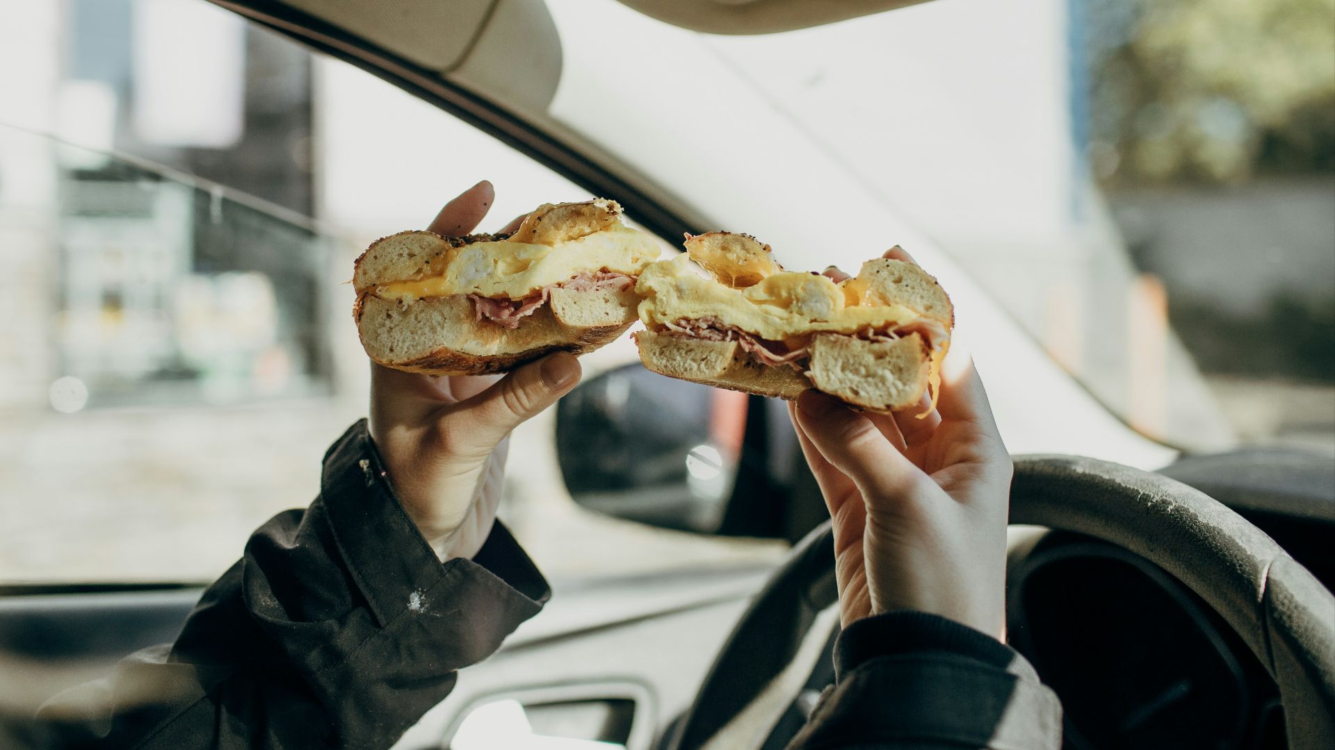 person holding bread with meat