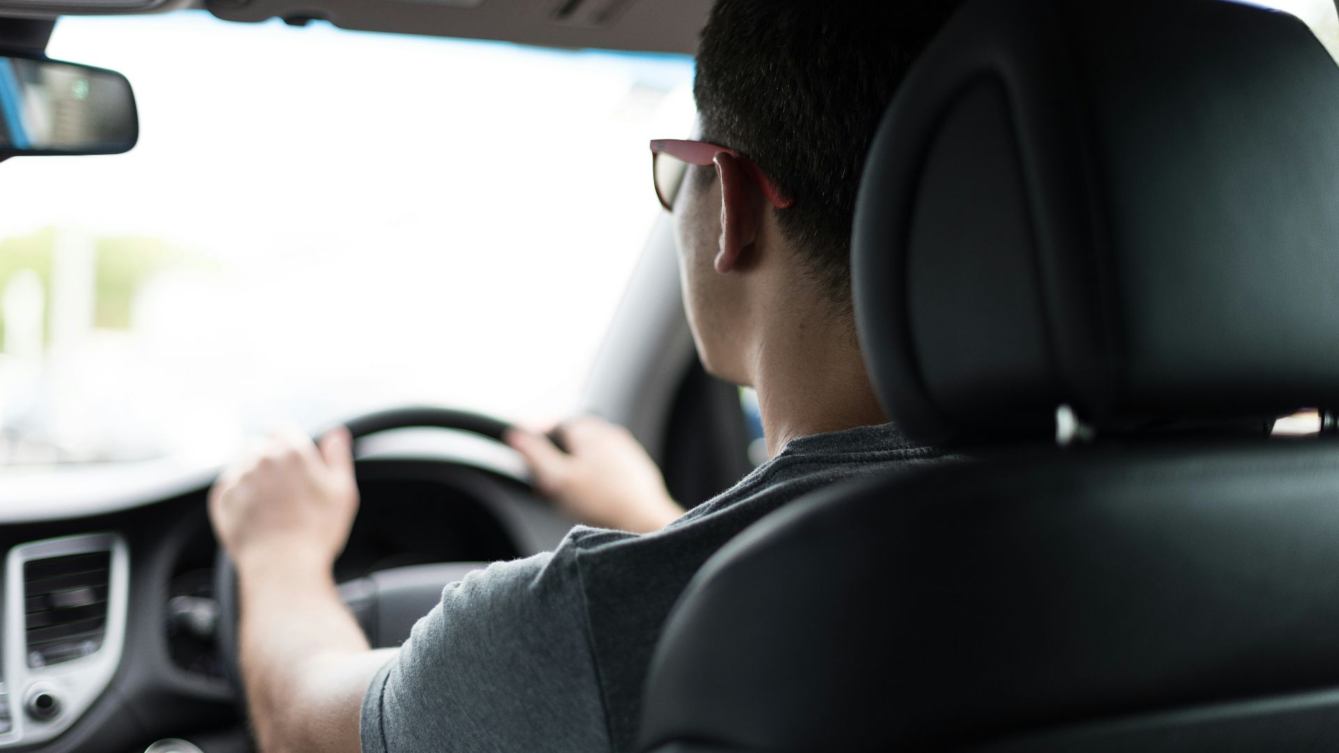 man driving car during daytime