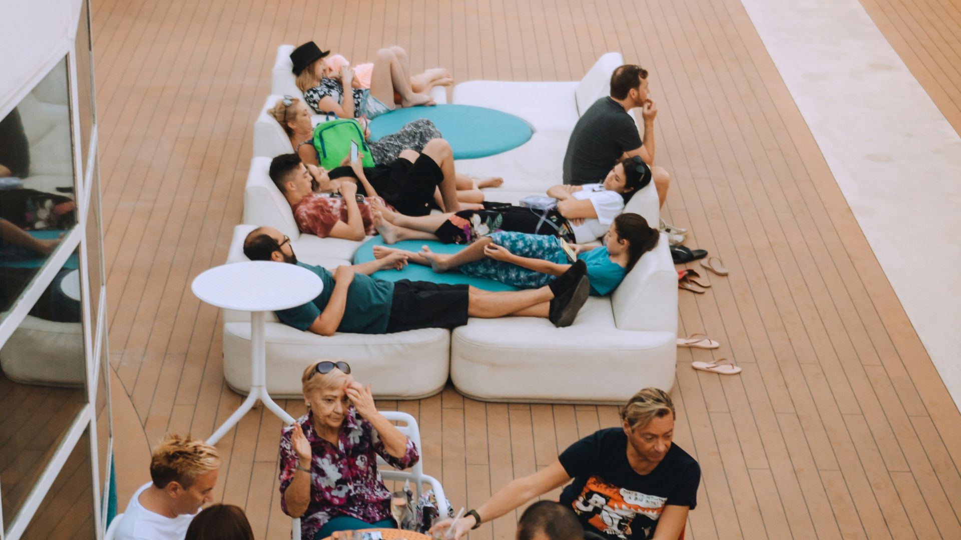 group of people sitting on blue and white chairs