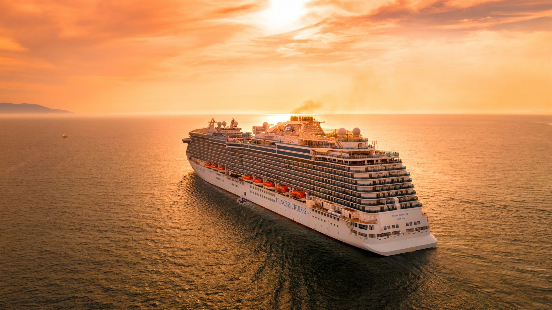 white ship on sea during sunset