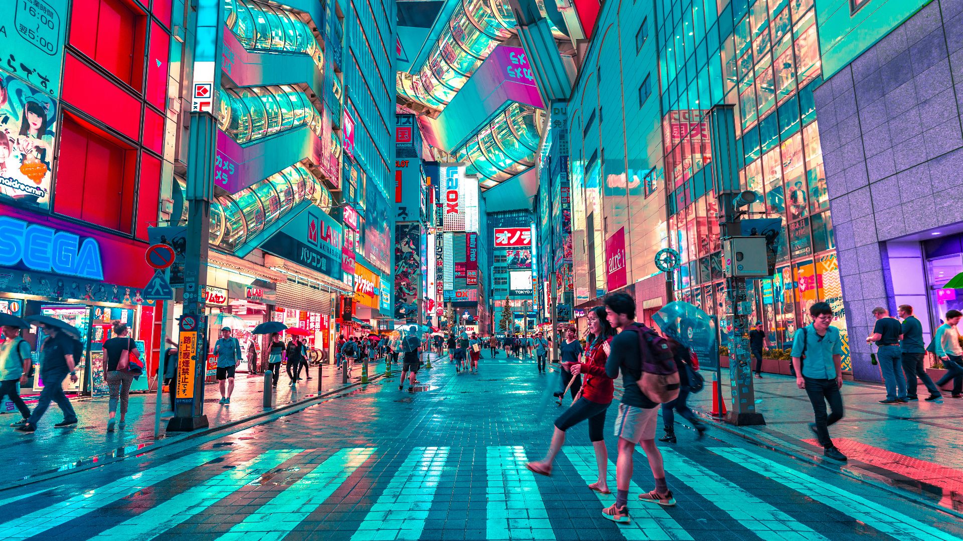 people walking on road near well-lit buildings
