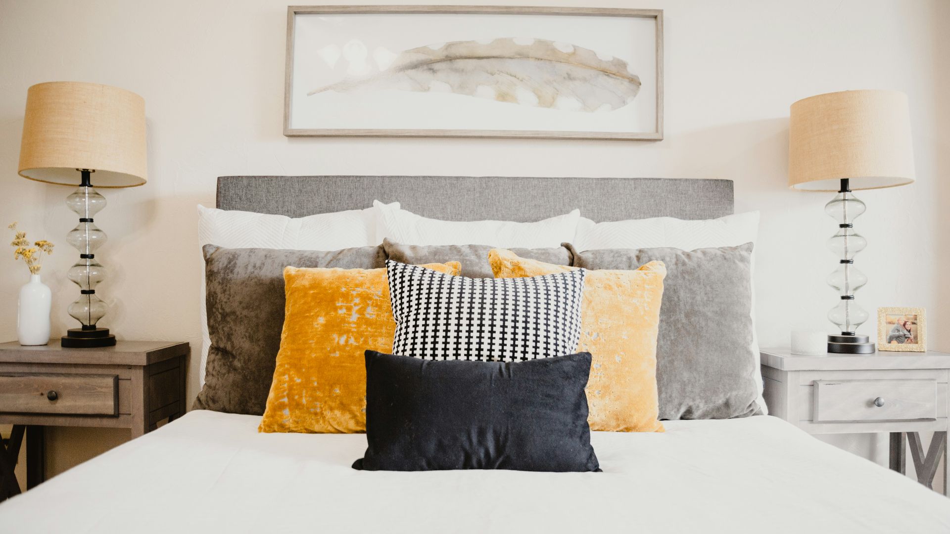 black and white throw pillows on white bed