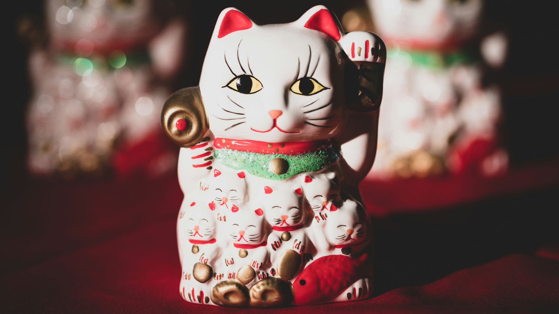 white and red ceramic cat figurine