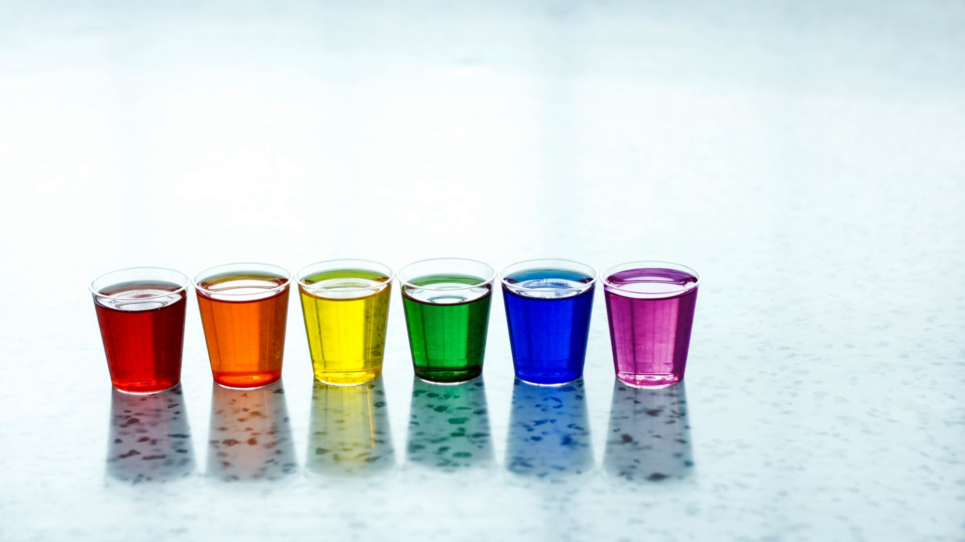 six assorted-color shot glasses