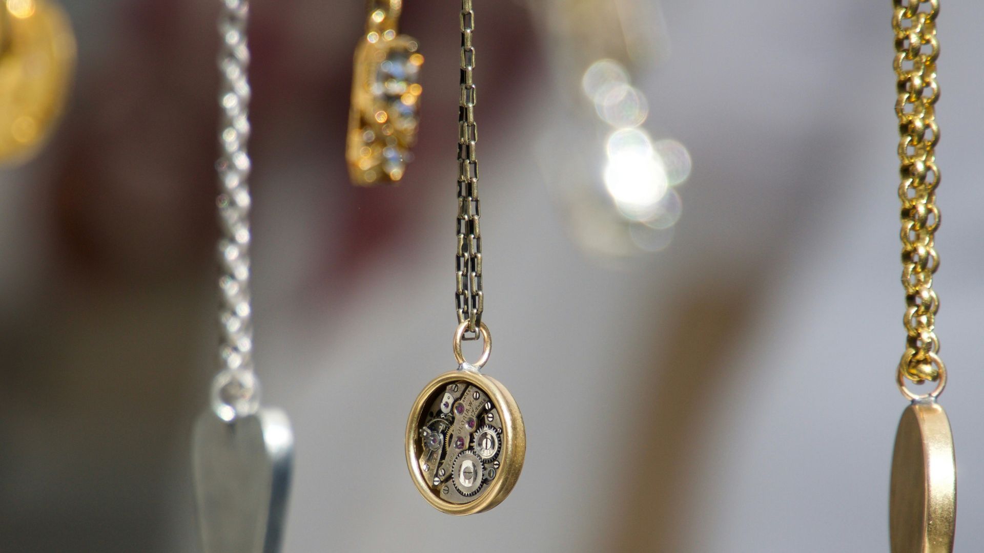 gold-and-silver-colored pendant necklace