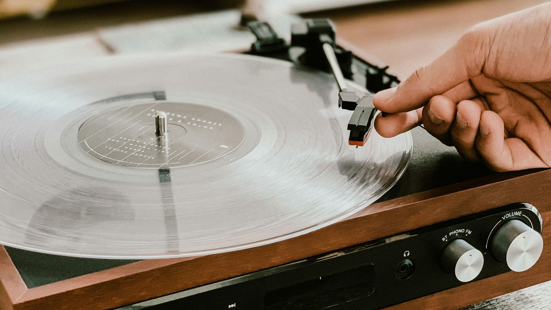 person playing record on Victrola turntable