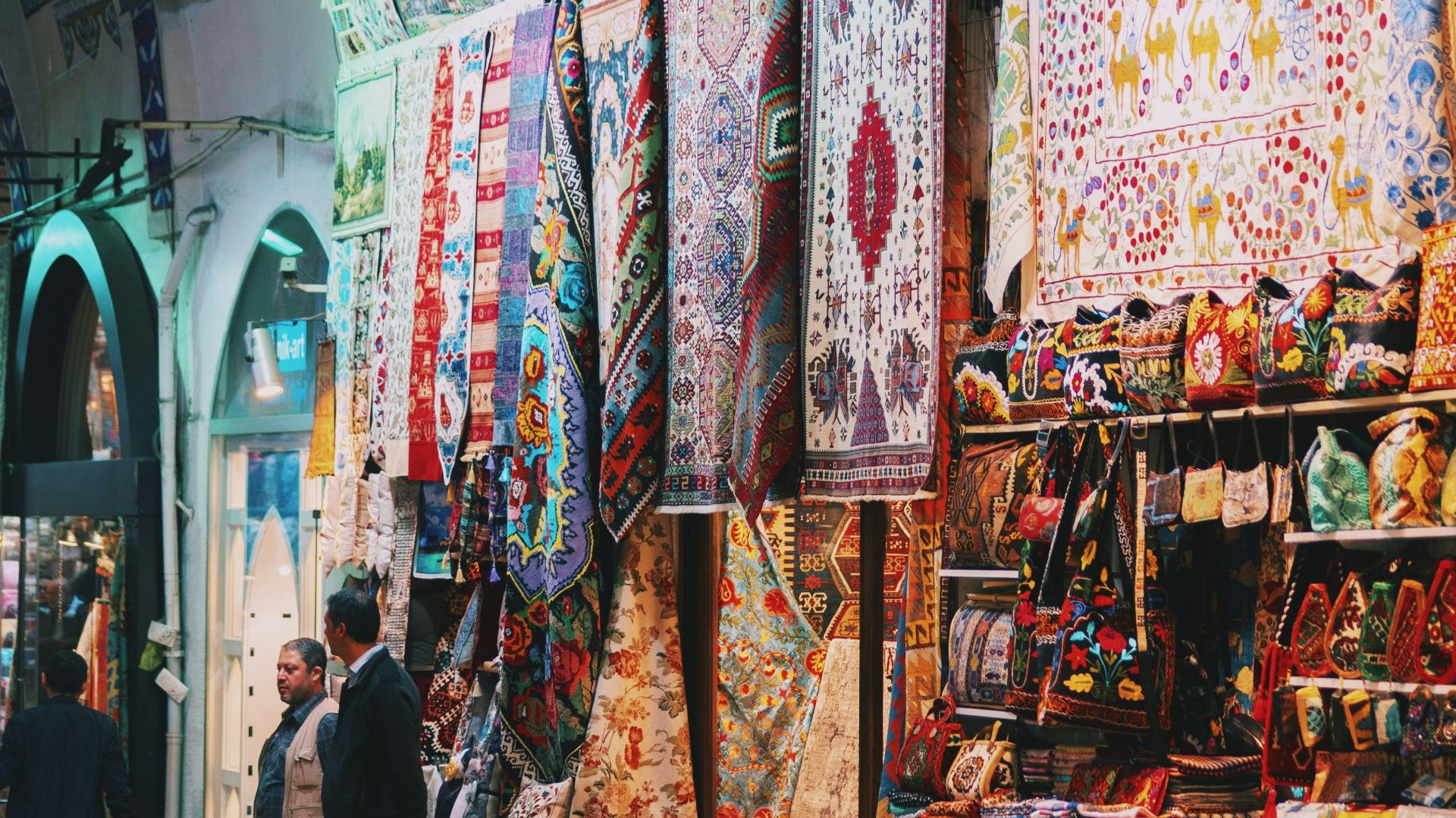 man in black jacket standing near store