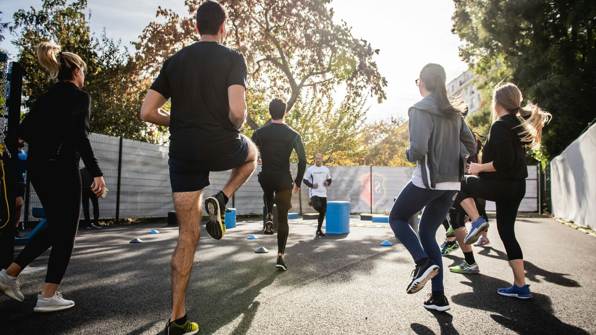 man in black t-shirt and black shorts running on road during daytime
