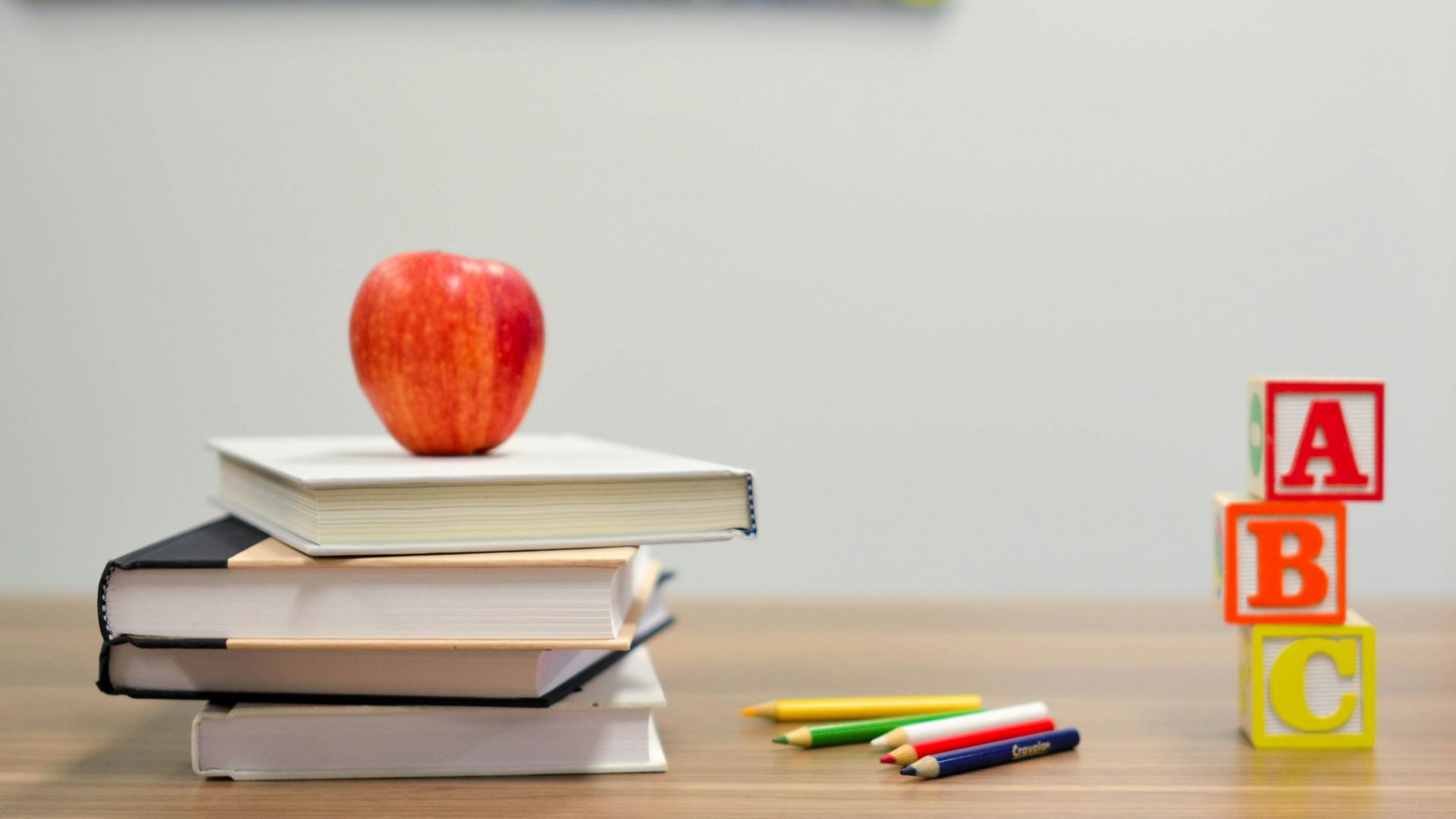 red apple fruit on four pyle books