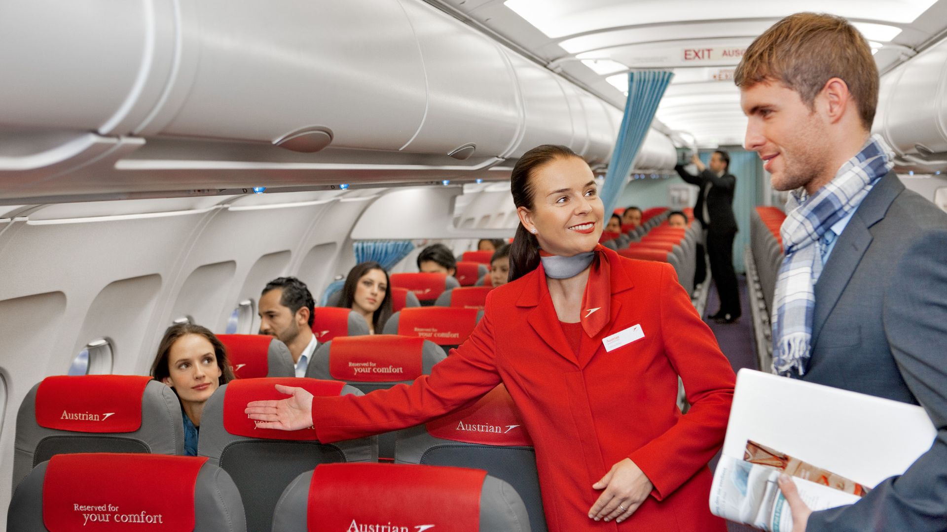 File:Austrian Airlines flight attendant and passenger.jpg