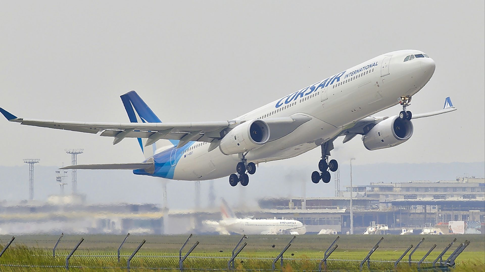 white and blue airplane about to fly at the airport
