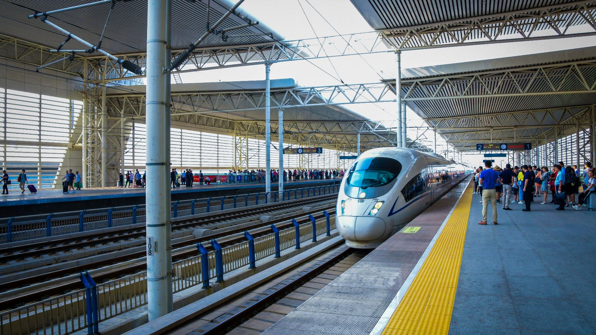 a bullet train pulling into a train station