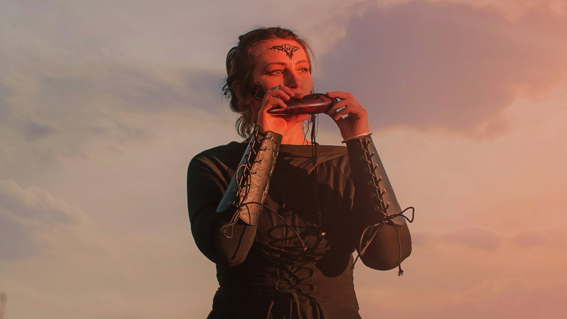 A woman standing in a field with a dog