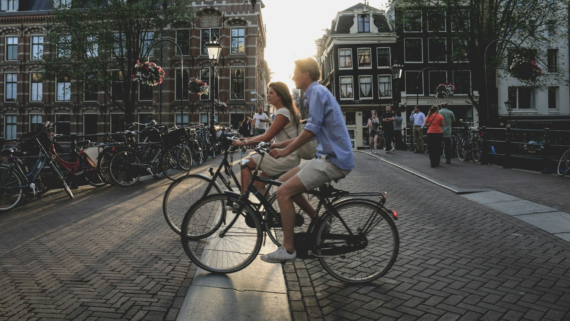man and woman biking along city at daytime