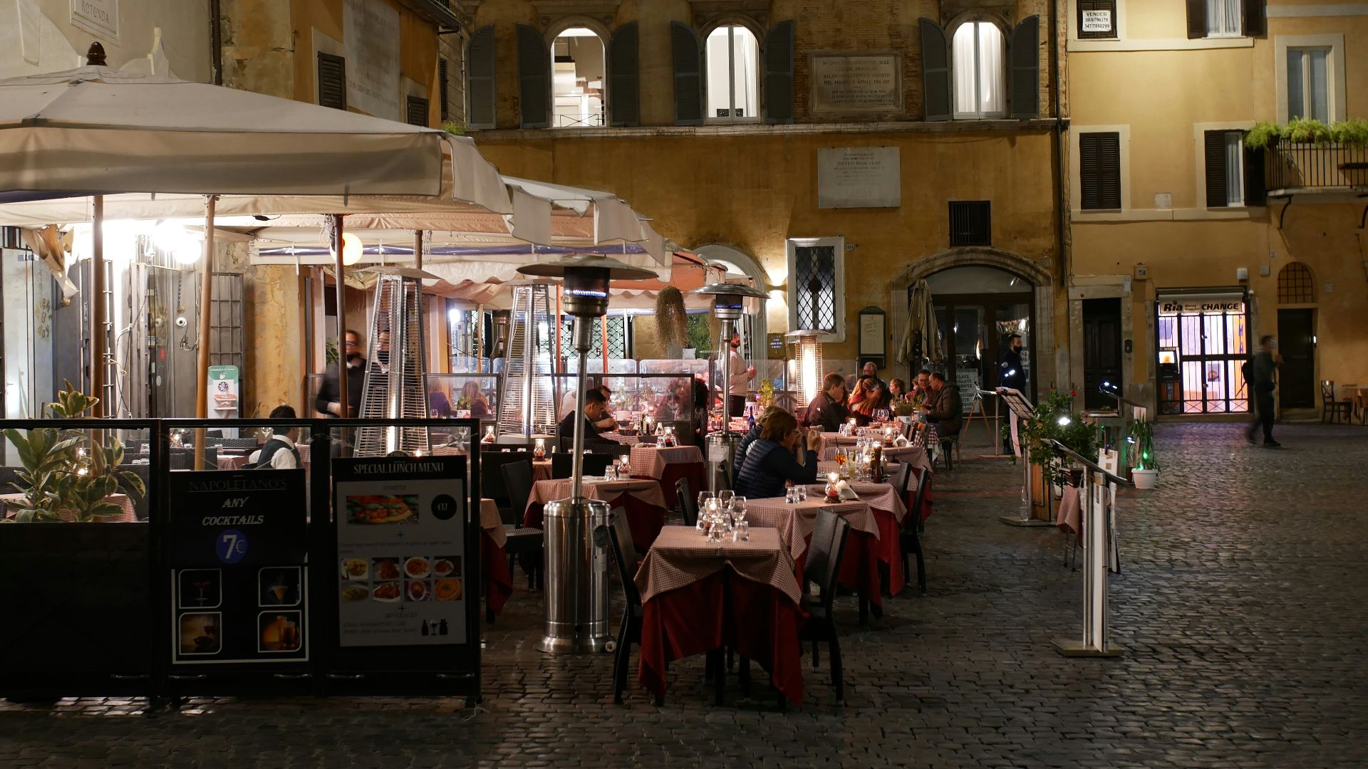 people sitting on chair near table and building during daytime