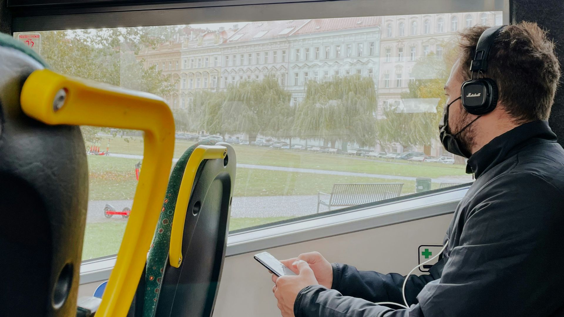 a man wearing headphones sitting on a bus