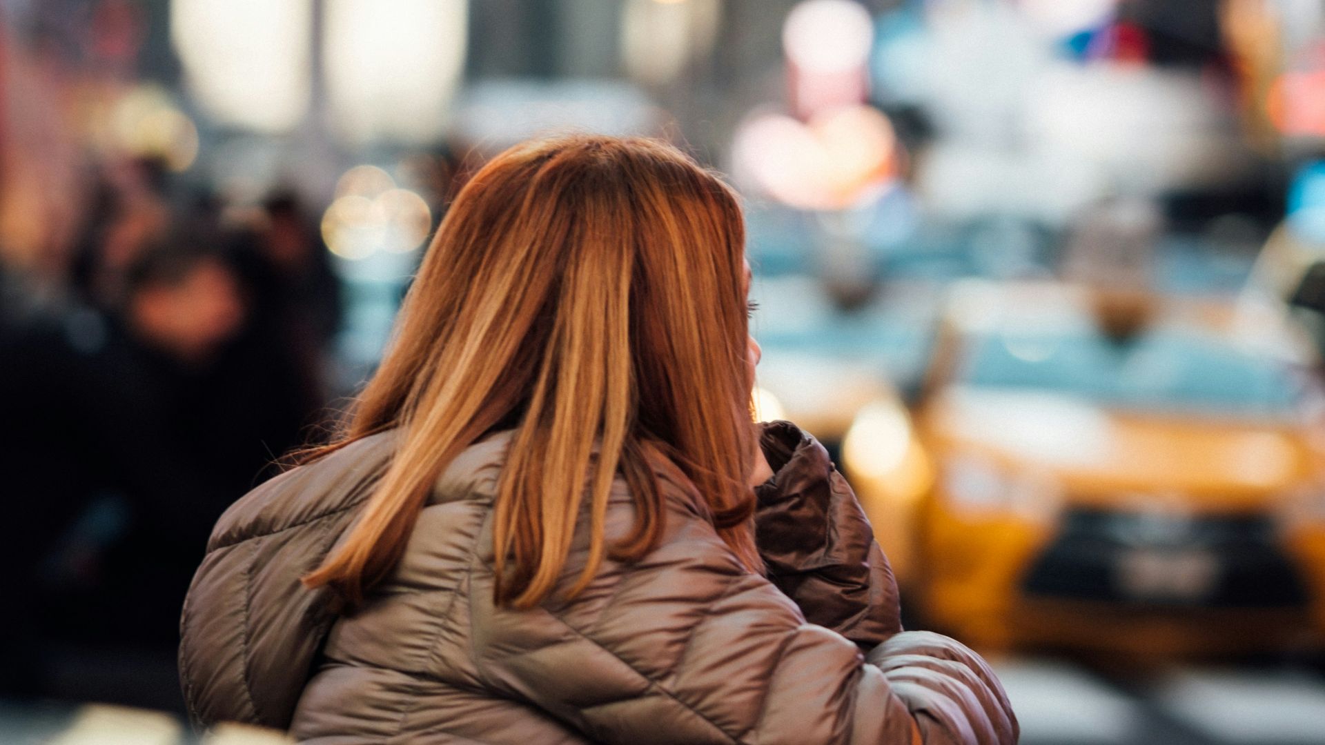 women leaning in a metal bar during daytime