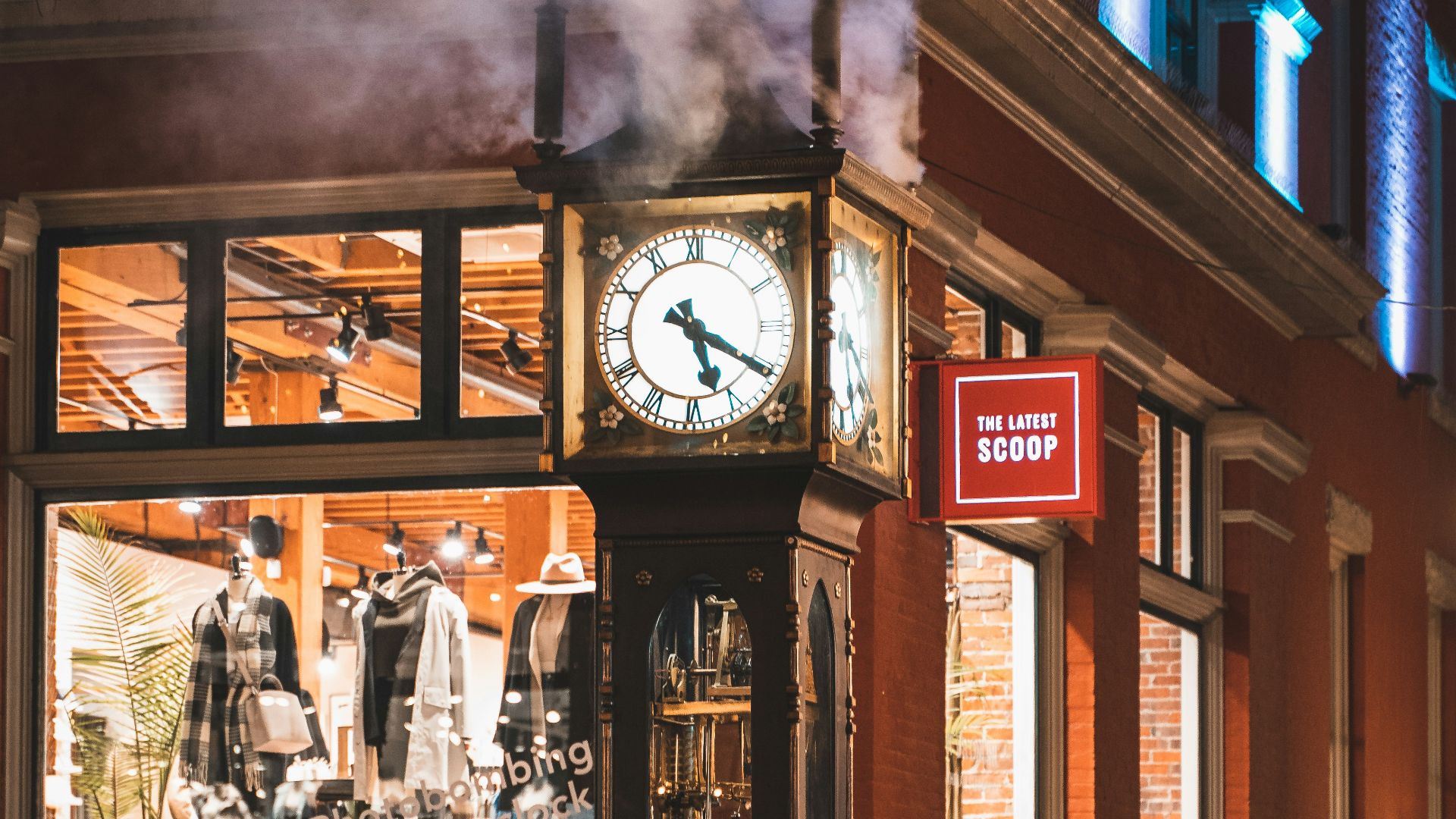 red and white analog clock at 11 00