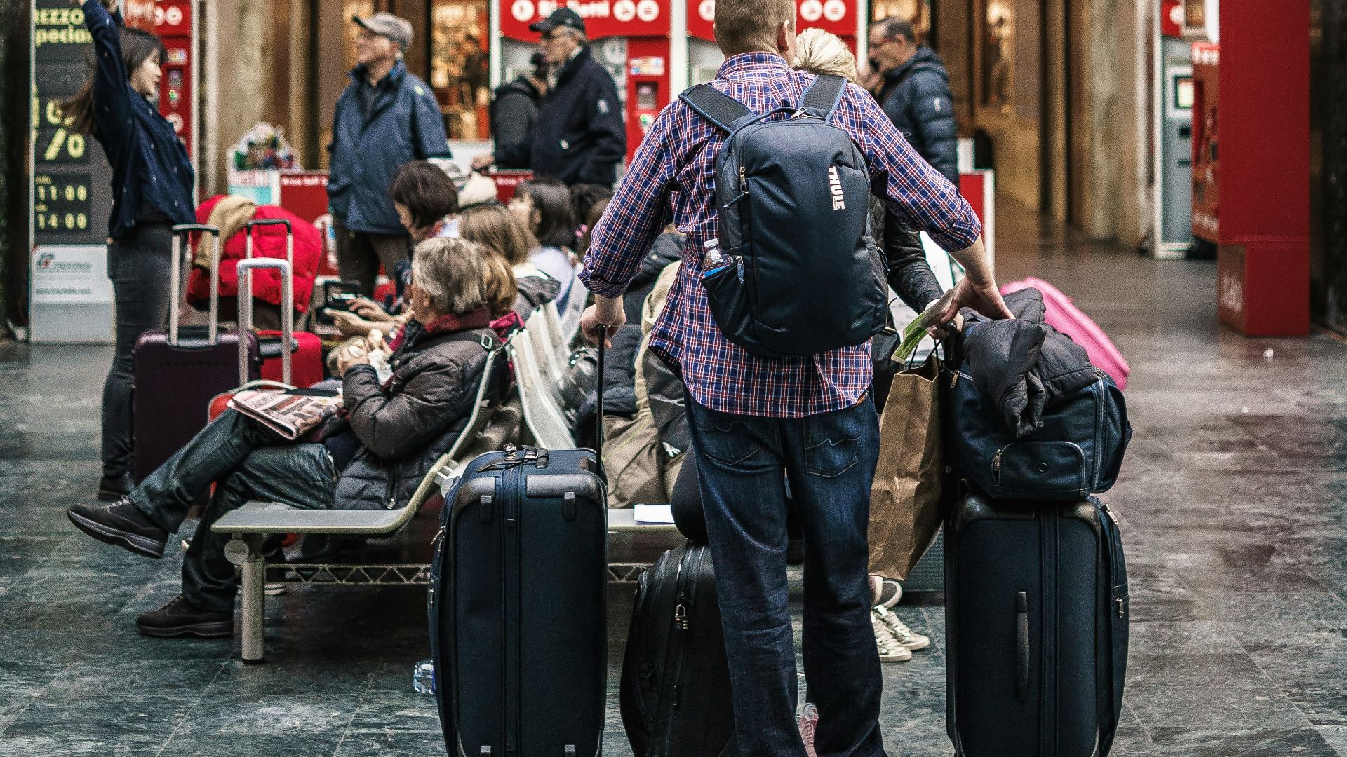 person standing beside the luggage bags