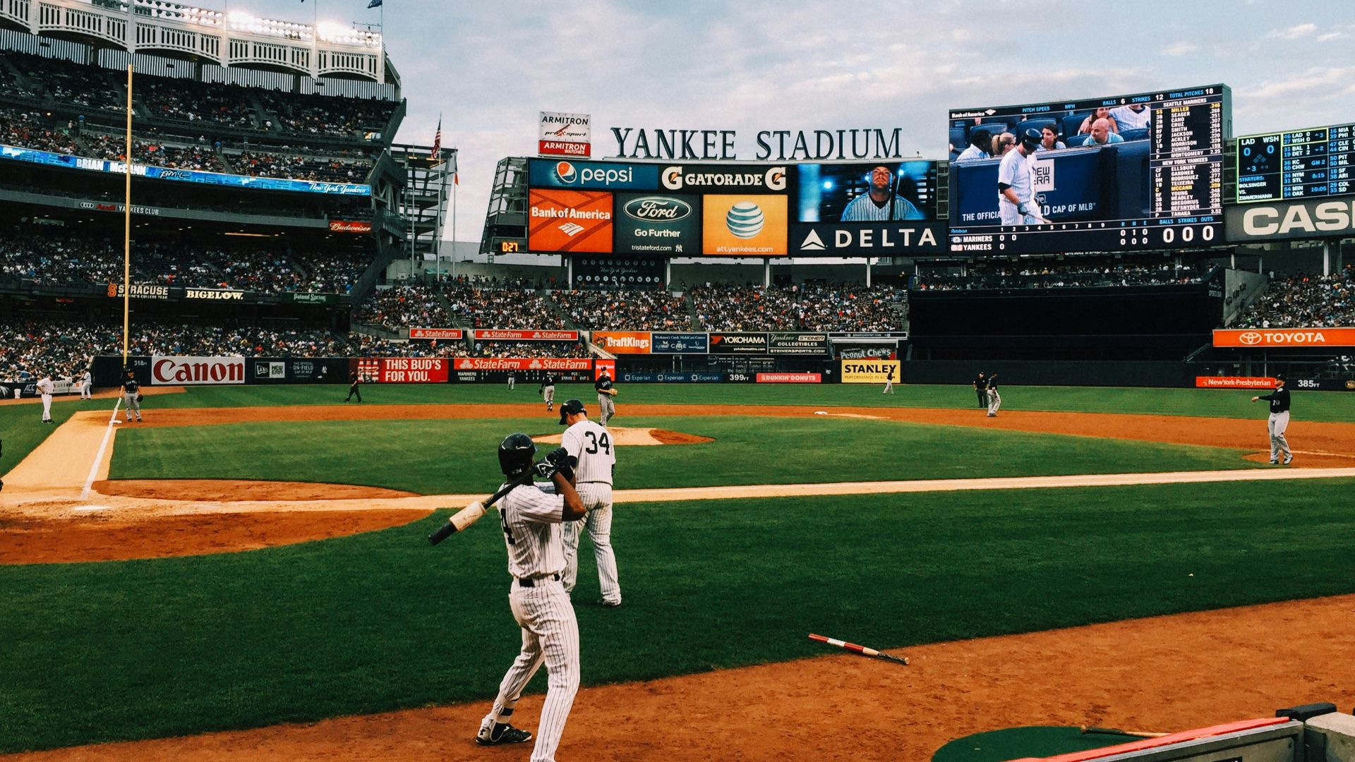 baseball players playing on field during daytime