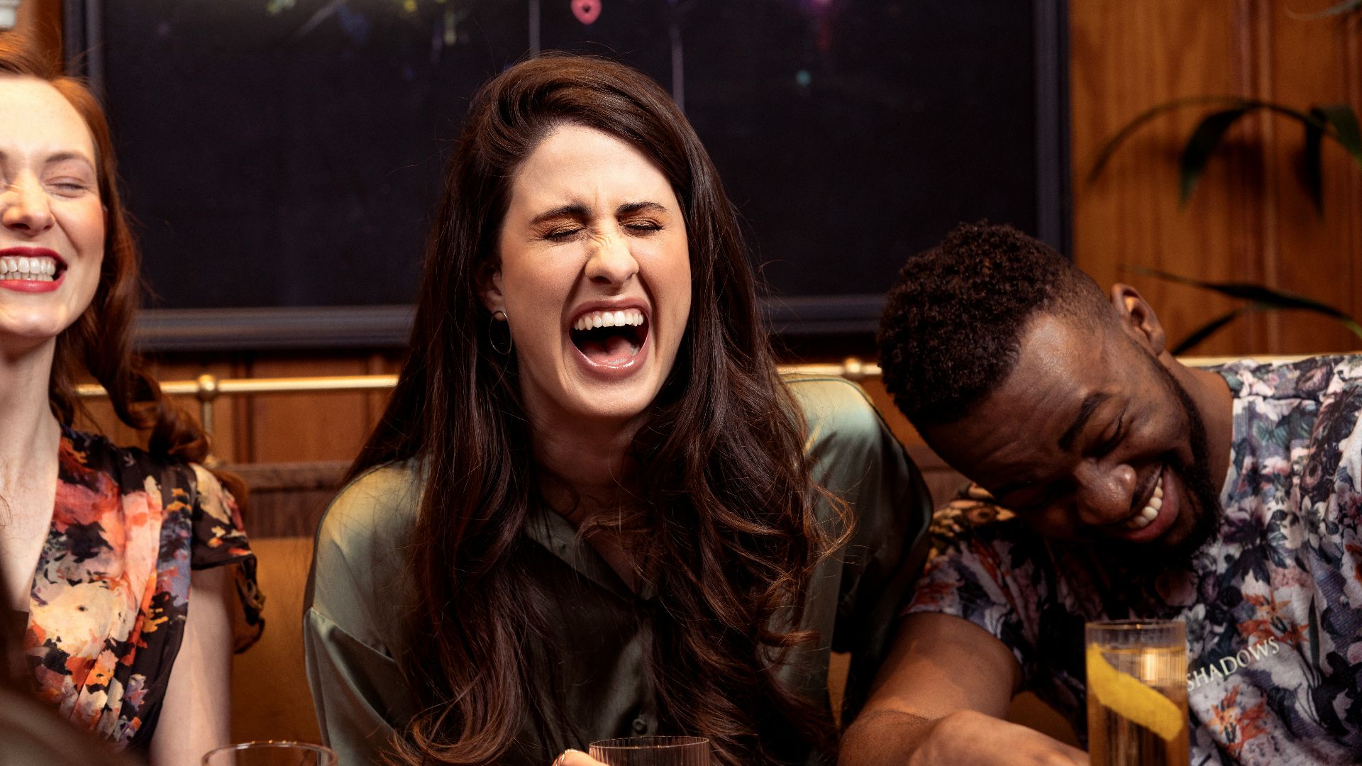 a group of people sitting around a table with drinks