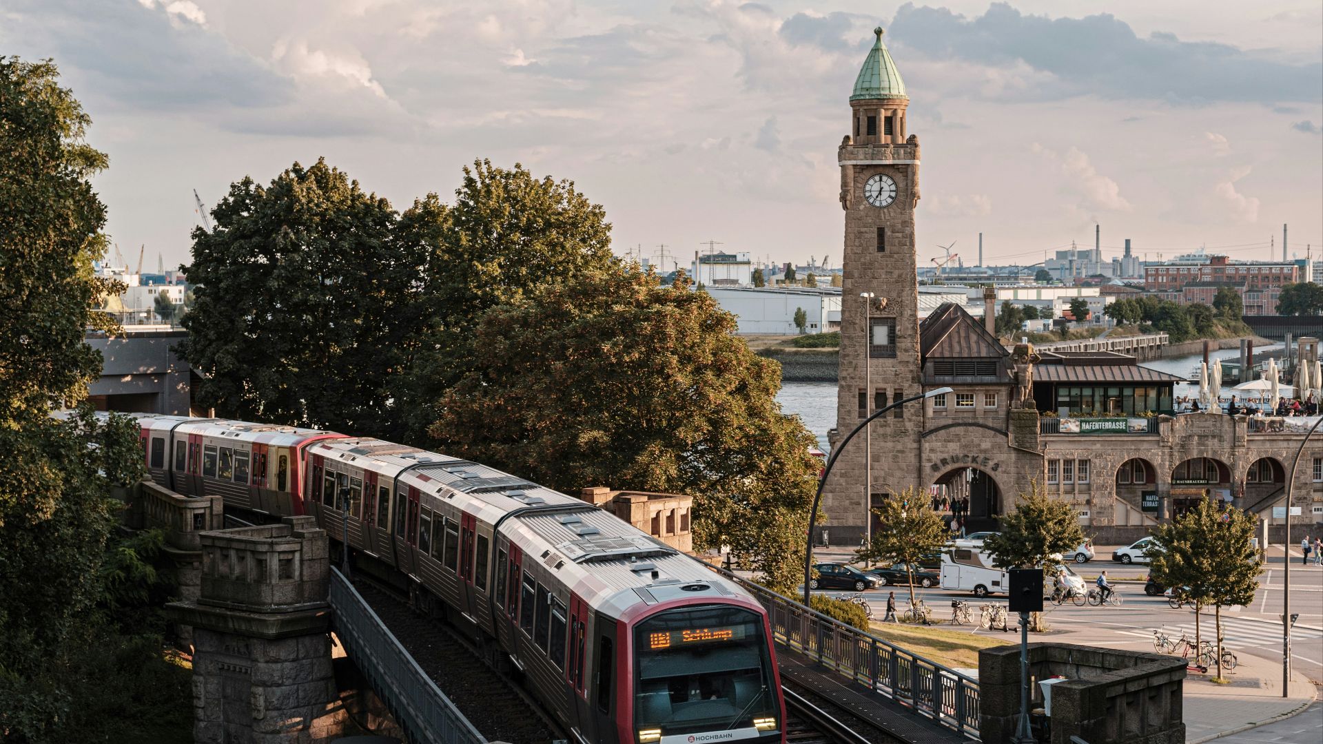 brown and white train on rail road near brown concrete building during daytime