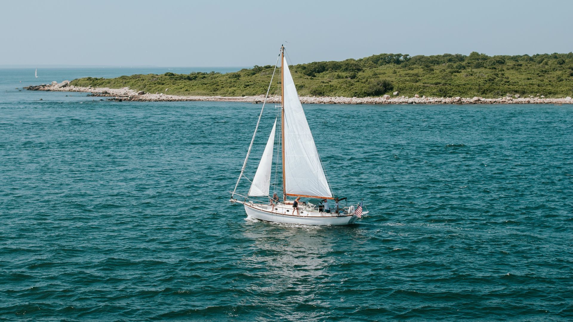 a sailboat in the middle of a body of water