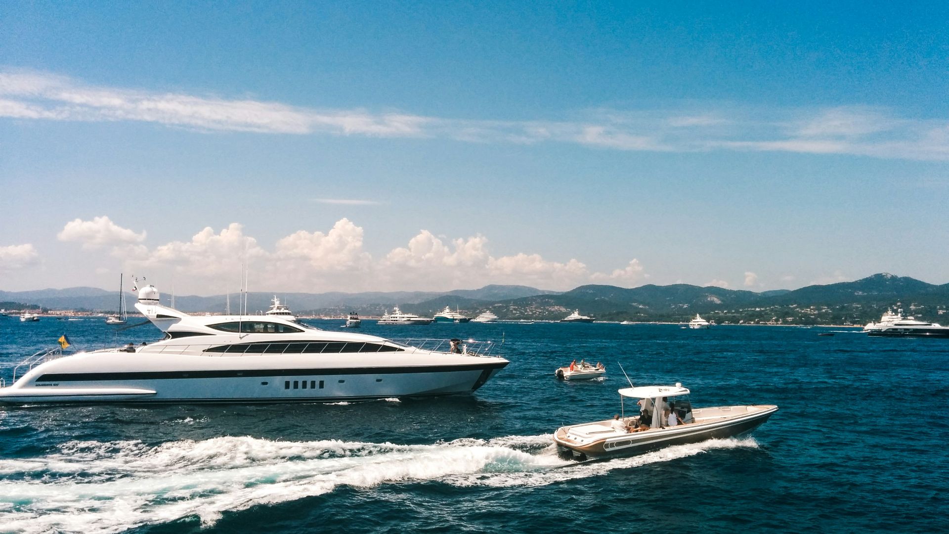 white and blue boat on sea under blue sky during daytime