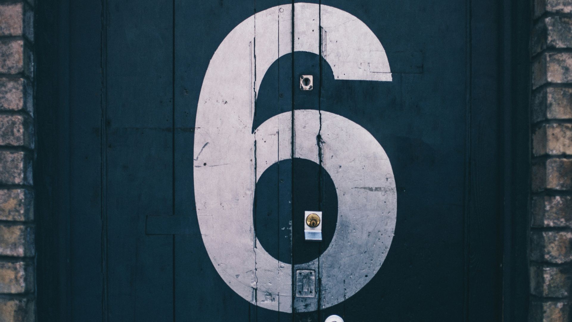 macro photography of blue wooden door painted with number 6