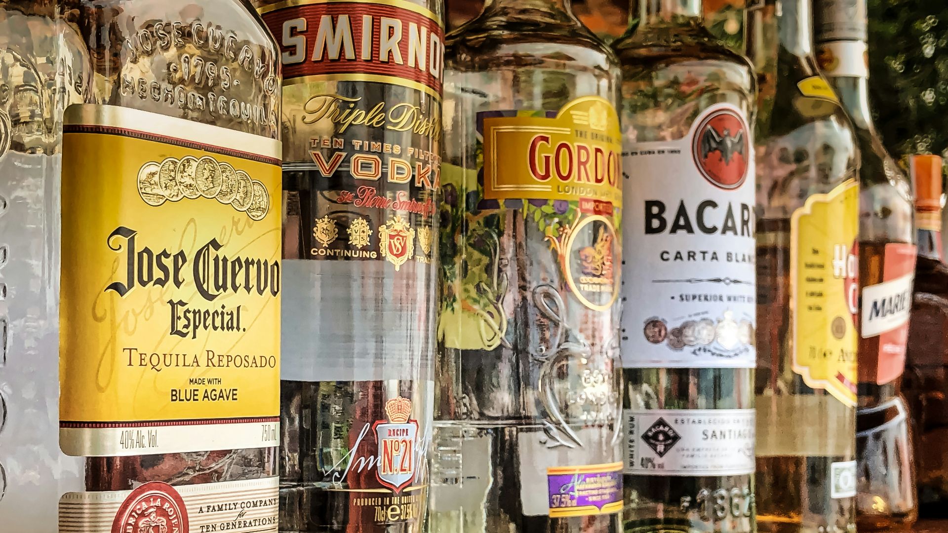 clear glass bottles on gray concrete floor