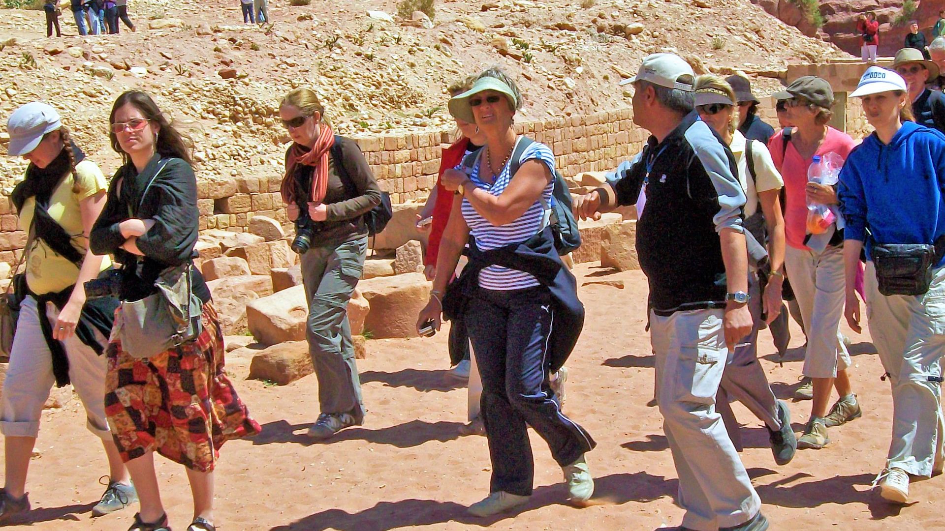 File:Tourists with guide in lower canyon, Petra.jpg