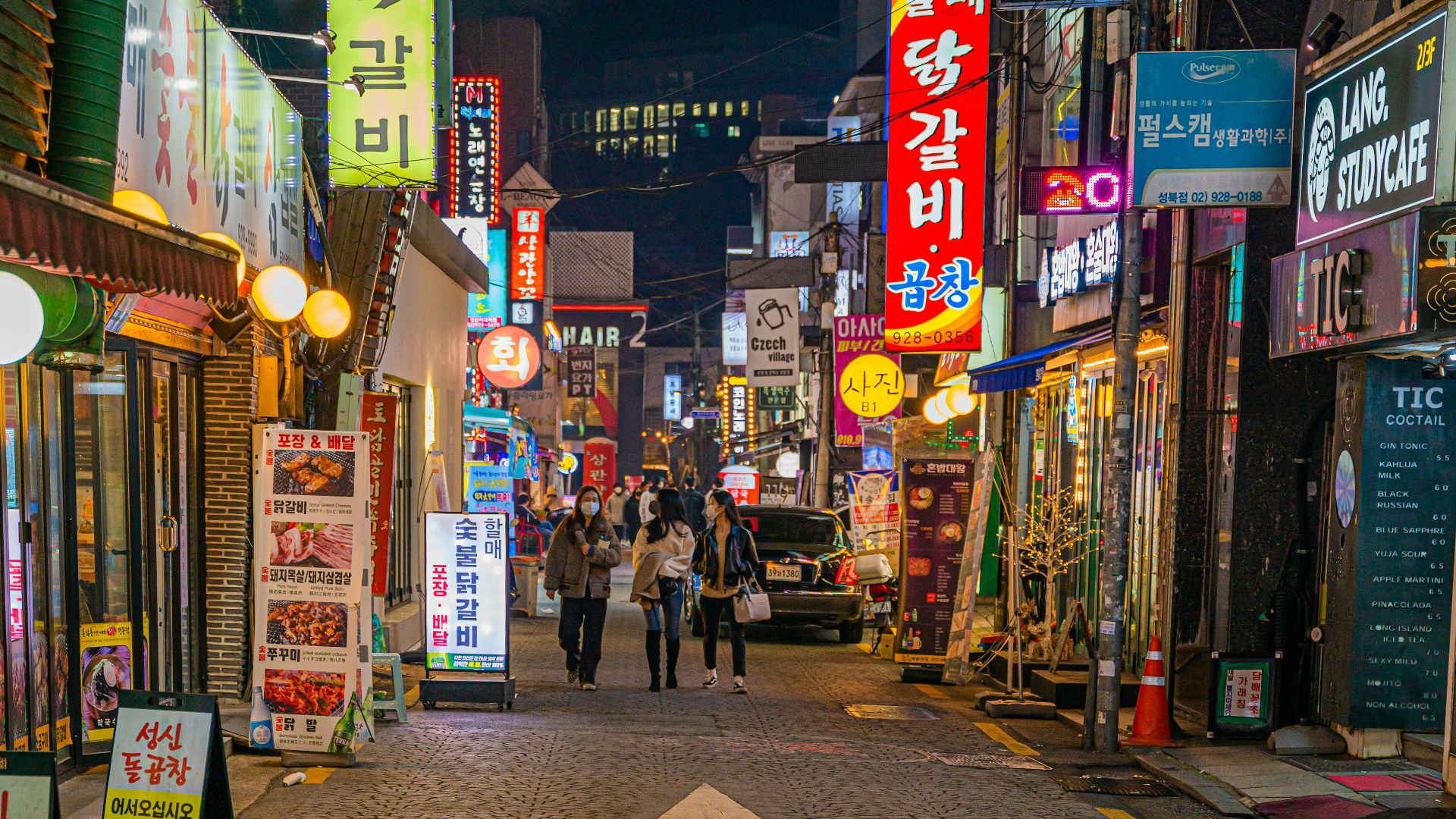 a city street filled with lots of neon signs