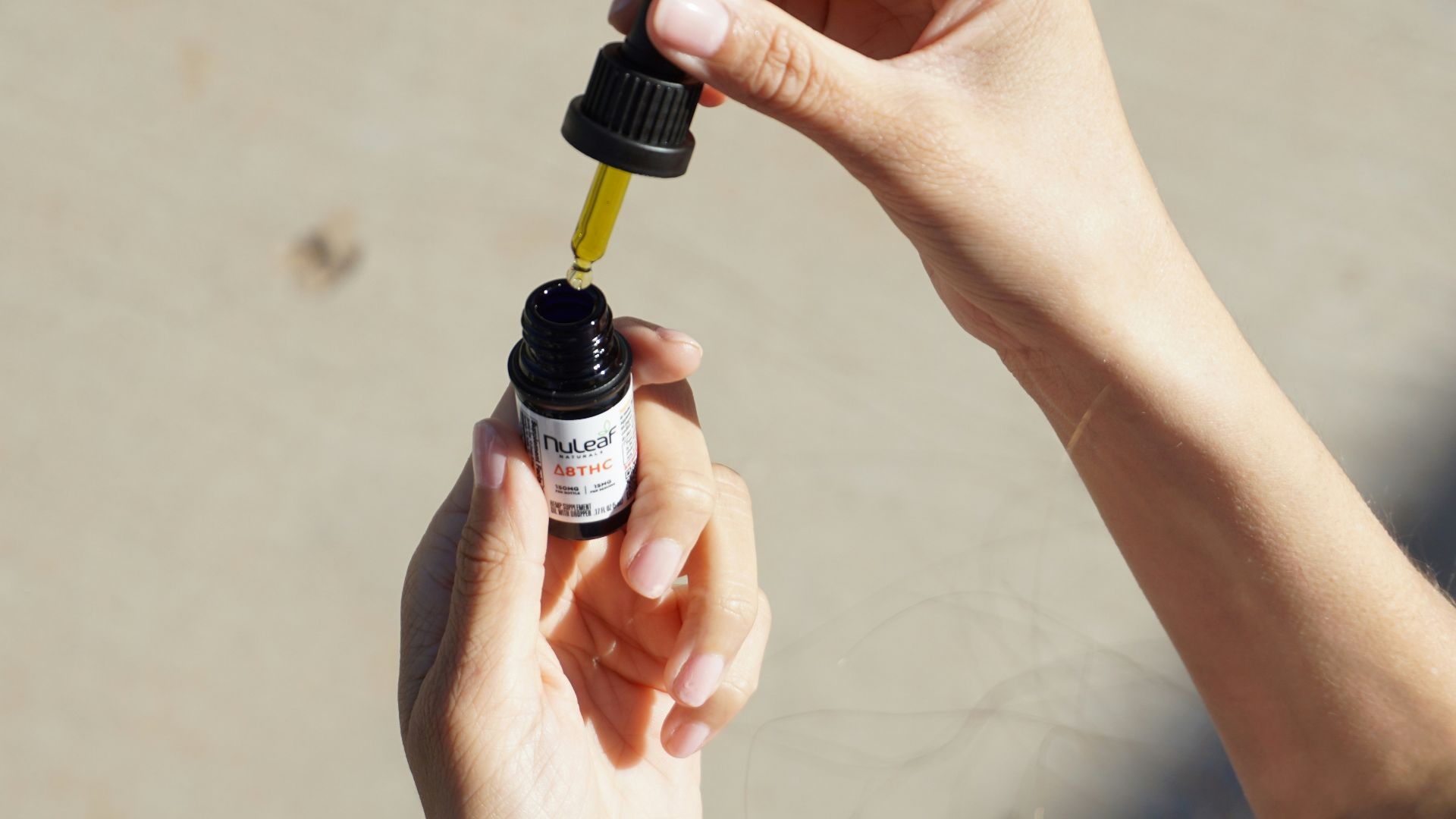 person holding black and white bottle