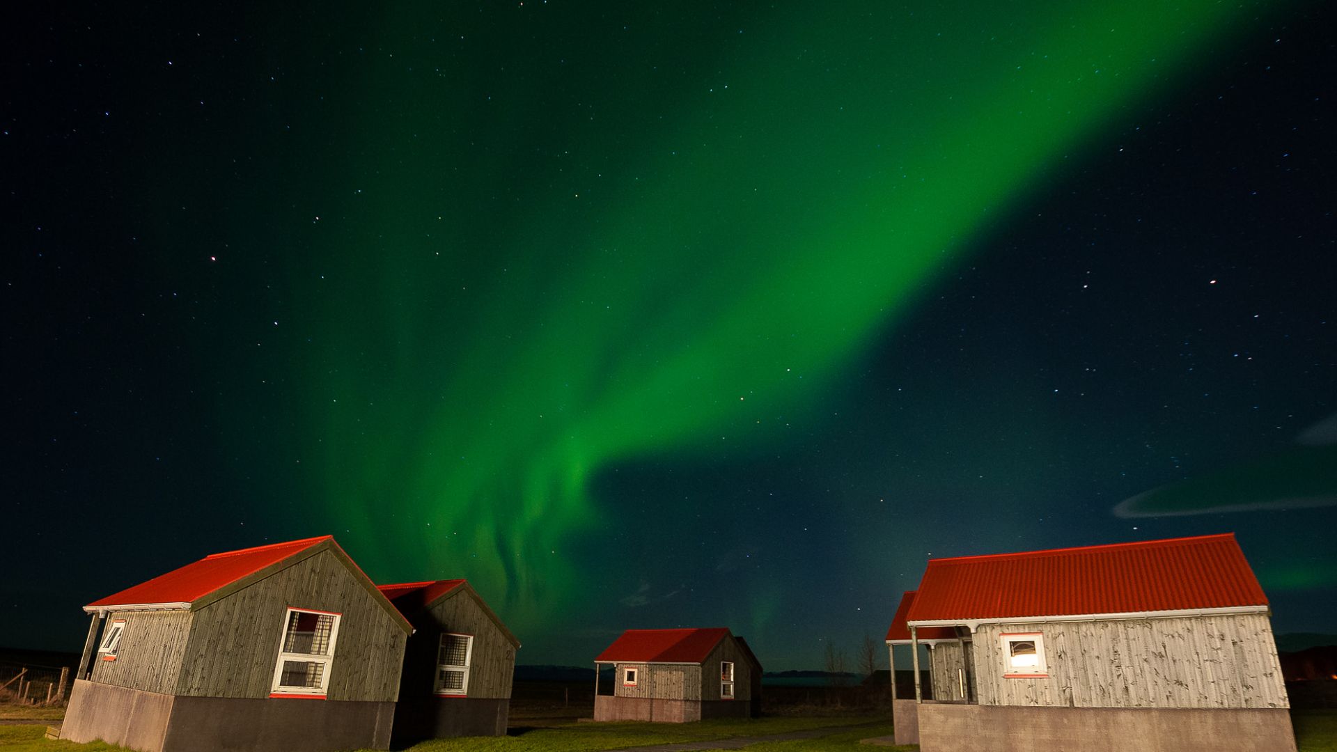 File:Northern Lights Over Red Roofed Cabins (63879565).jpeg