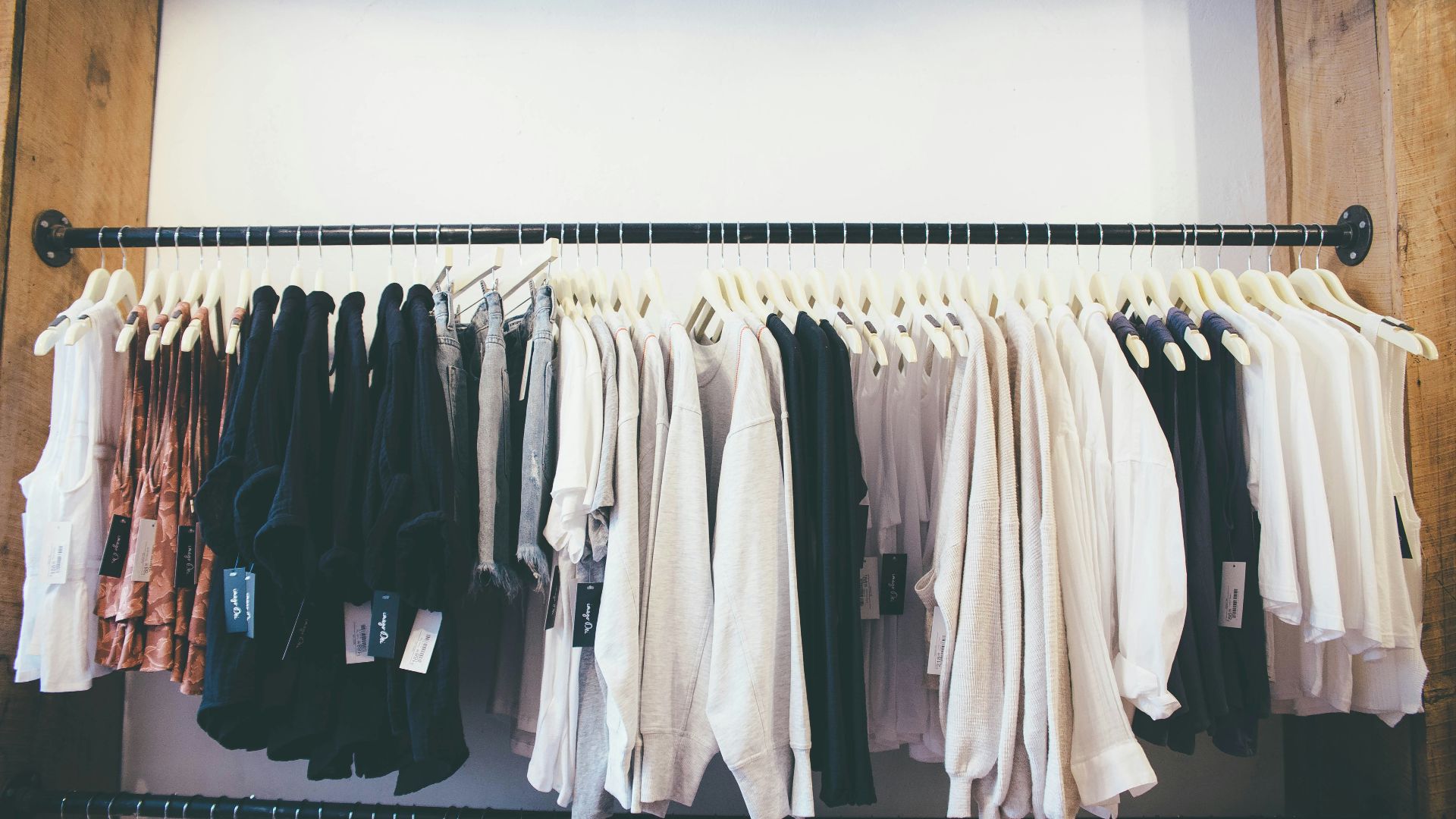 white long sleeve shirt hanging on black steel rack