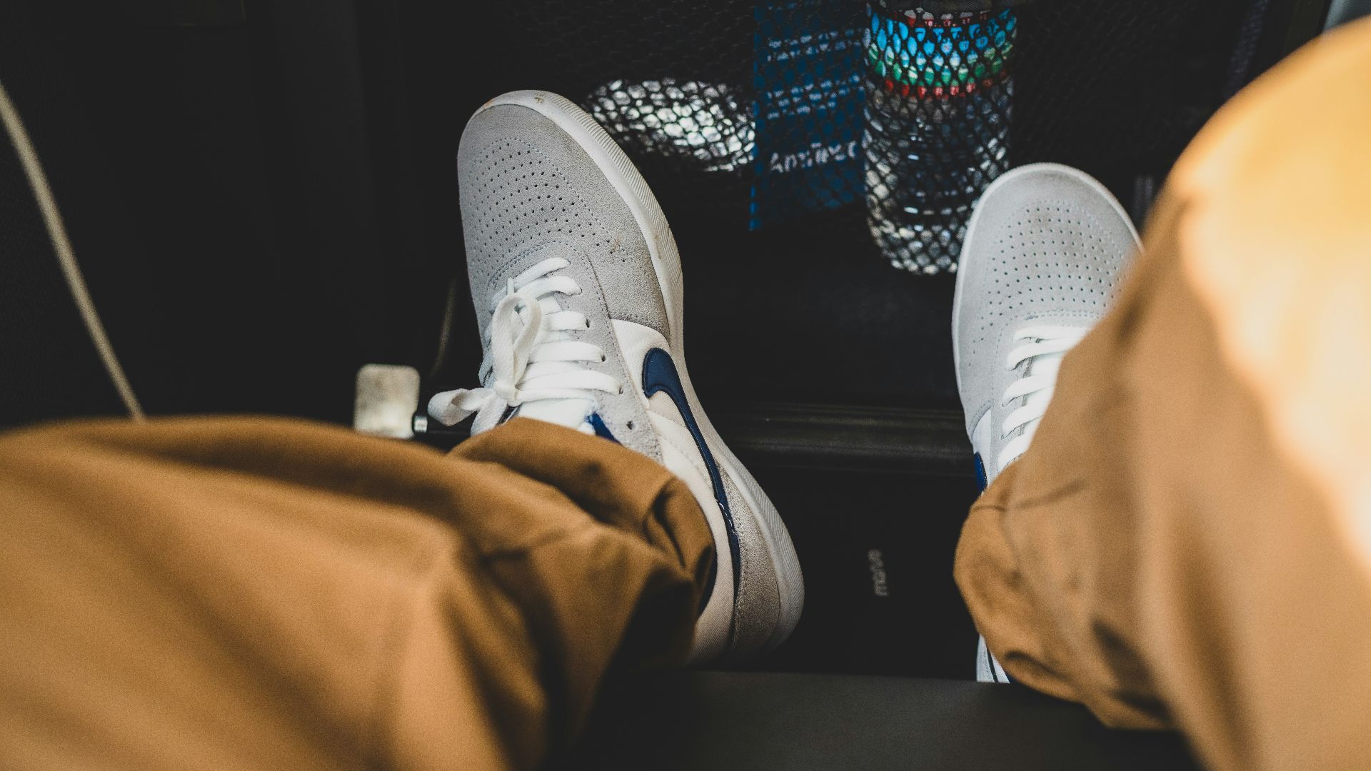 person wearing gray and white nike sneakers