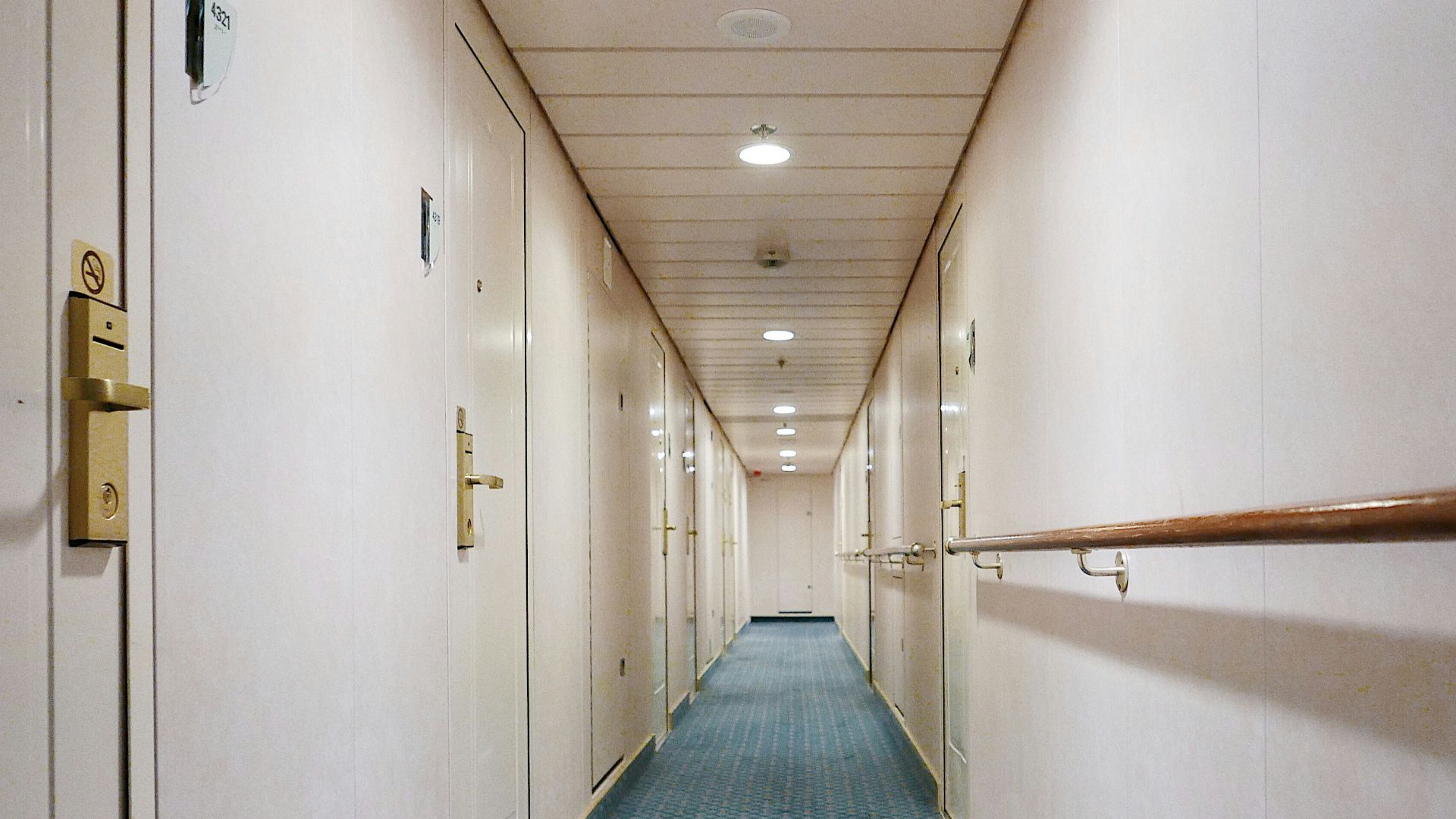 a long hallway with a blue tile floor