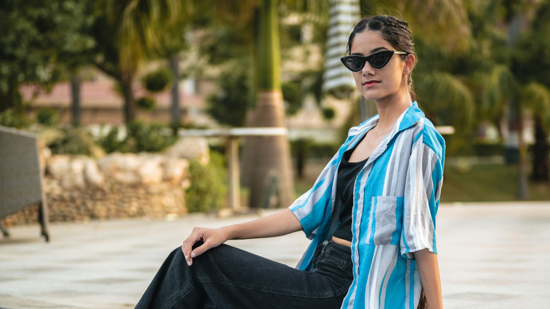 A woman sitting on the edge of a swimming pool