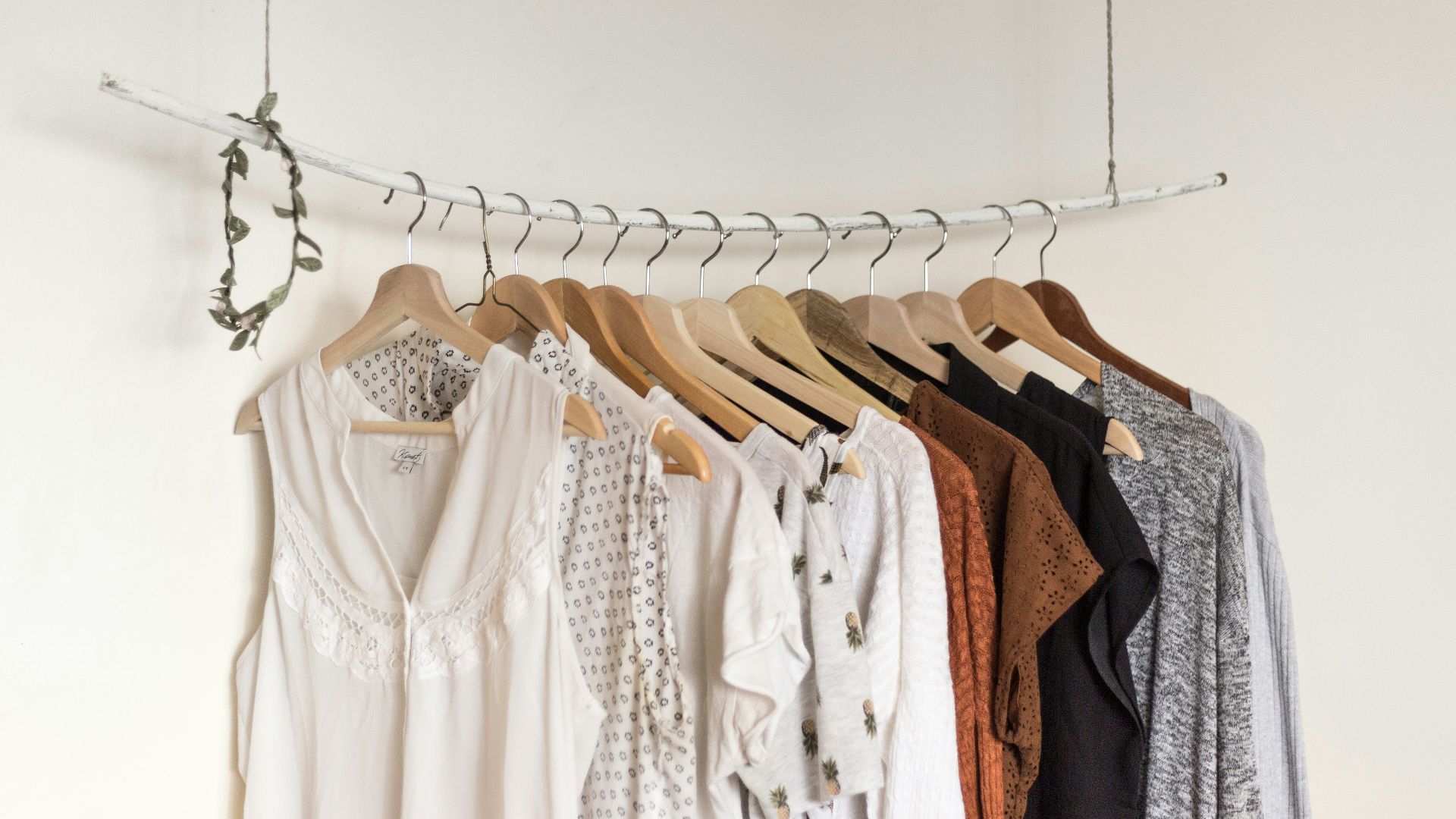assorted clothes in wooden hangers