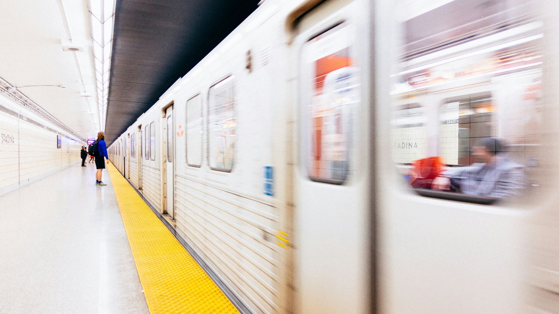 selective focus photography of person standing on train station