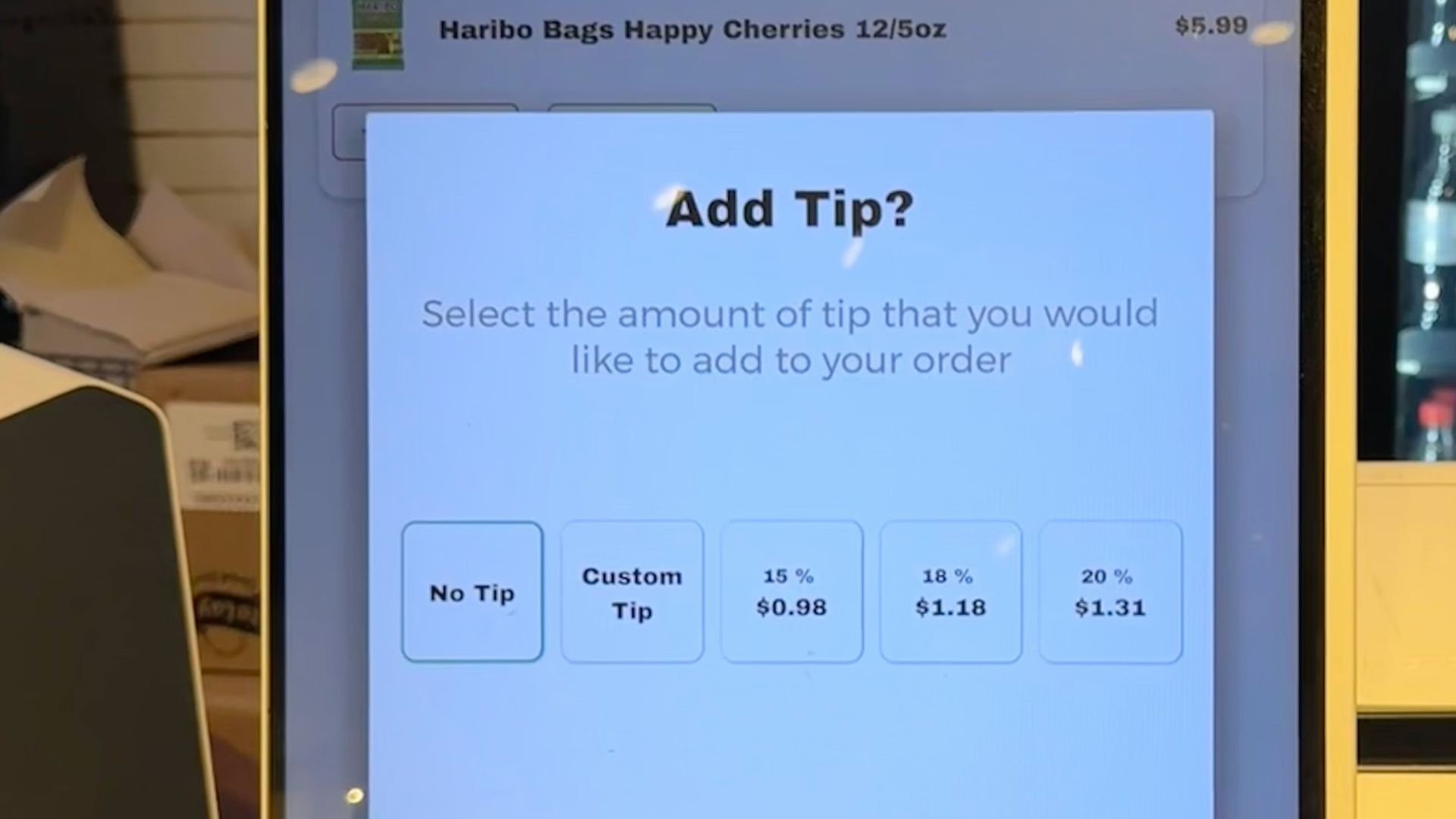 A checkout counter with a cell phone on it