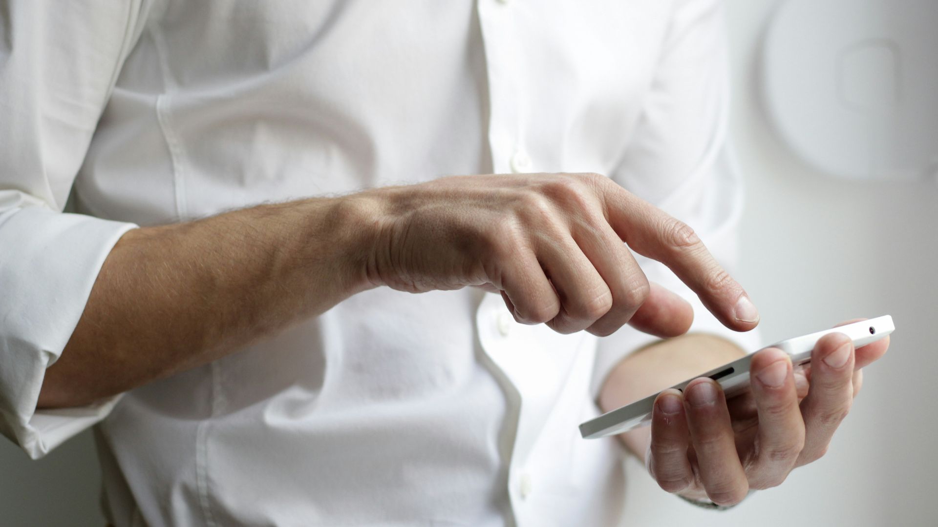 person holding white Android smartphone in white shirt