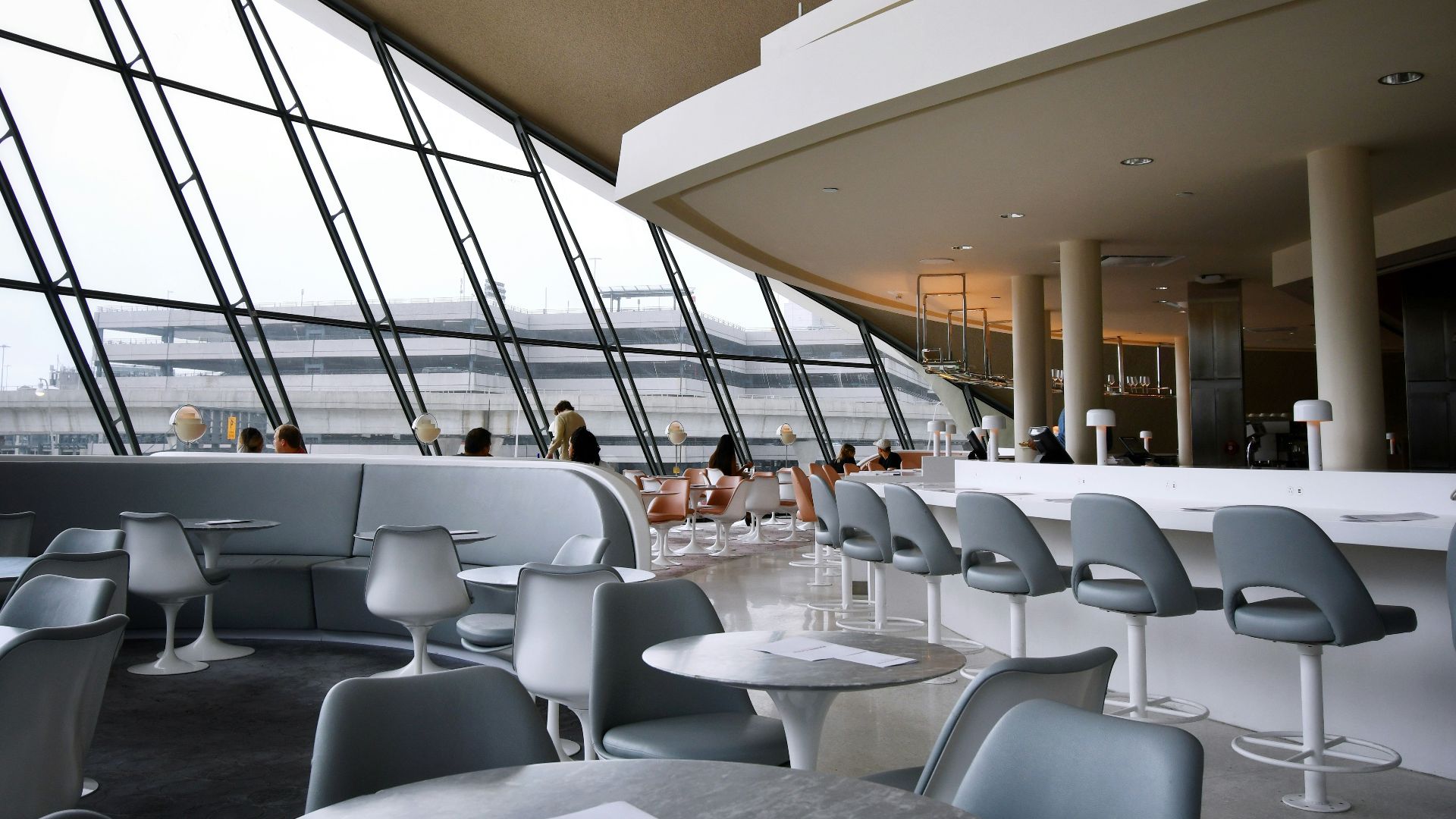 people sitting on white chairs inside building