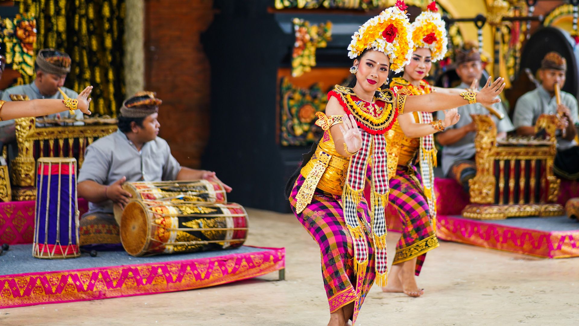 woman in red and yellow sari dress sitting on floor