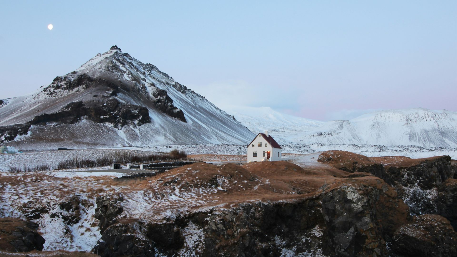 brown and white concrete house with distance to brown mountain