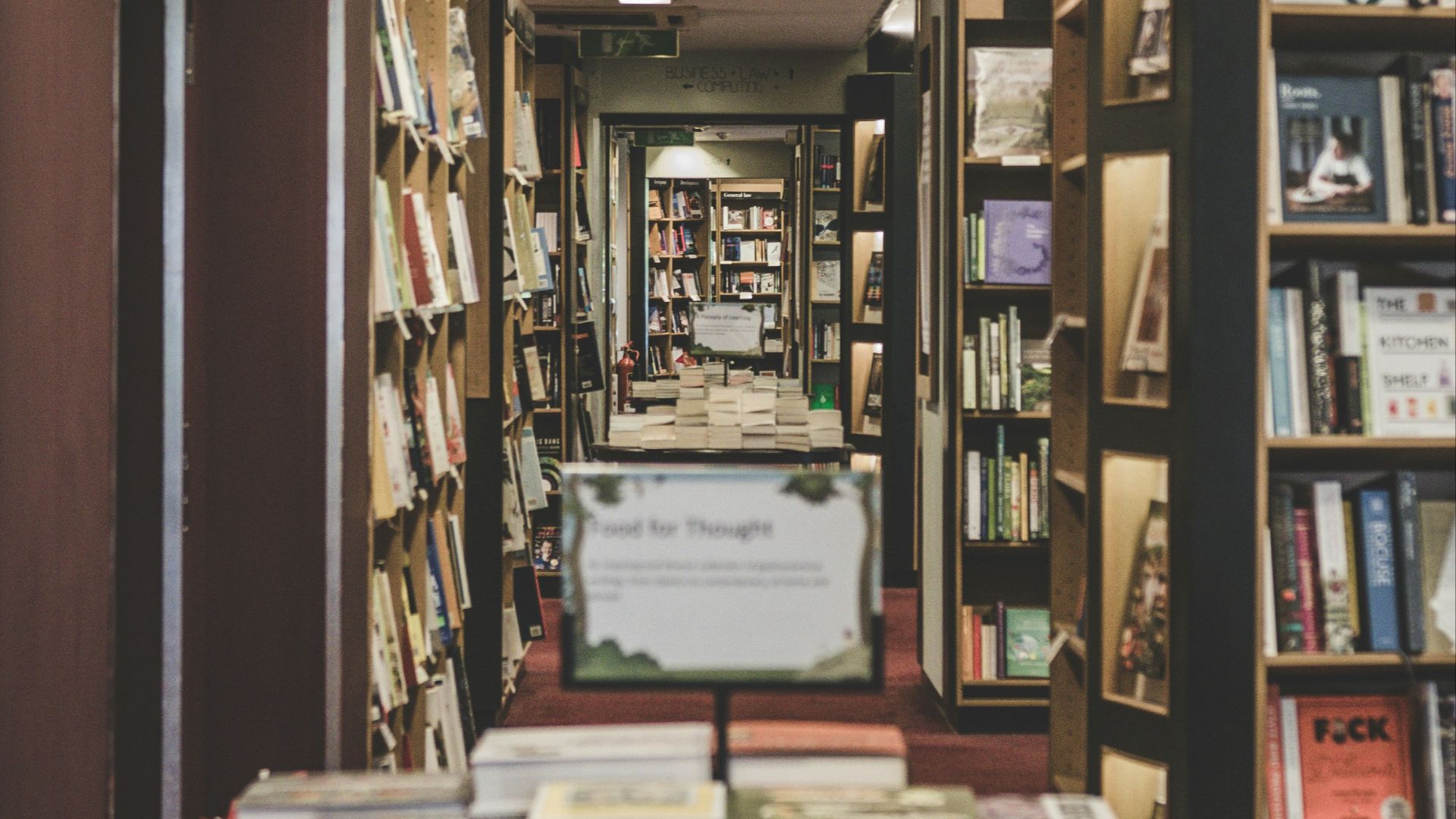 books on top of table located in the library